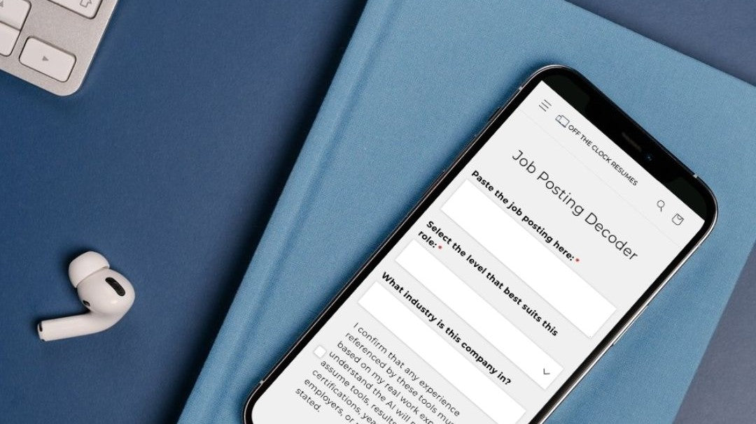 Smartphone mockup of Job Posting Decoder AI tool on blur book and desk